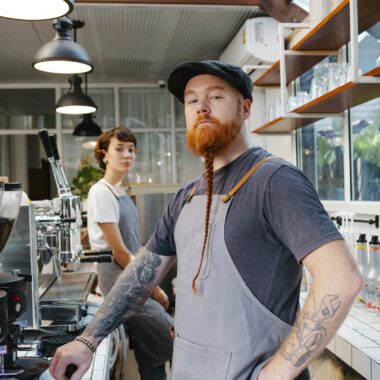 Professional bartenders in aprons in kitchen